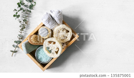 Spa composition with care products in a wooden box on white isolated. 135875001