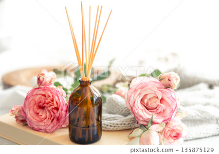 Spa composition with incense sticks and pink flowers. 135875129