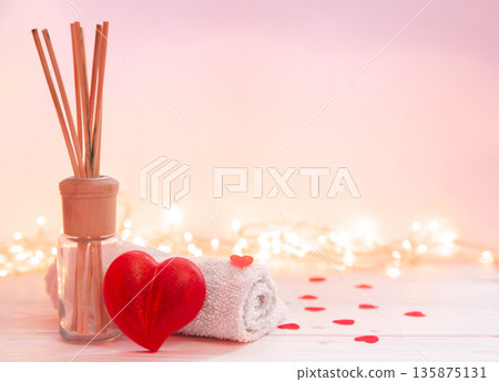 Spa composition with incense sticks, towel and heart shaped soap. Spa composition with incense sticks, towel and heart shaped soap. 135875131