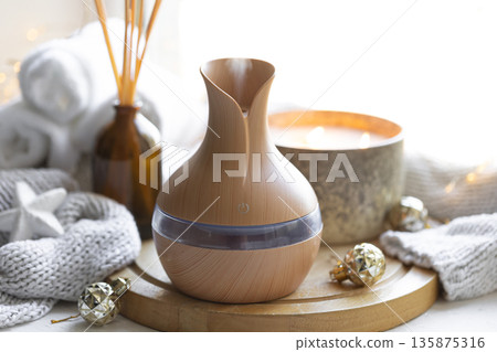 Still life with an aroma diffuser for moisturizing the air and winter decor. 135875316