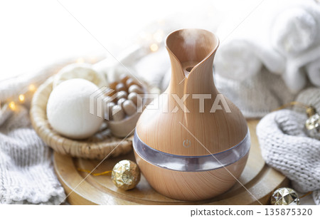 Still life with an aroma diffuser for moisturizing the air and winter decor. 135875320