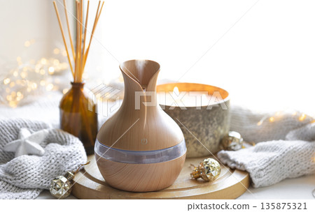 Still life with an aroma diffuser for moisturizing the air and winter decor. 135875321