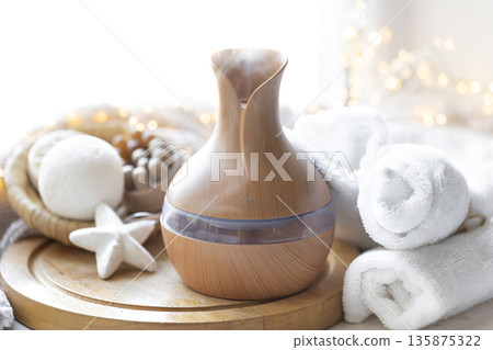 Still life with an aroma diffuser for moisturizing the air and winter decor. 135875322