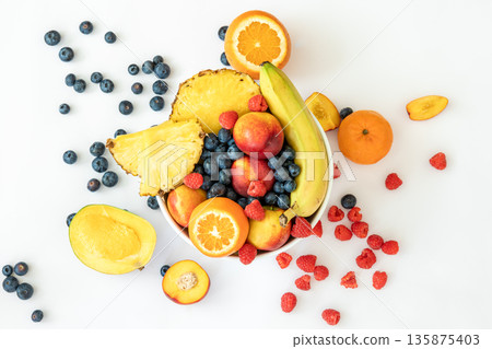 Tropical fruits on a white background top view. 135875403