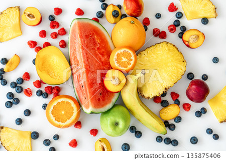 Tropical fruits on a white background top view. Tropical fruits on a white background top view. 135875406