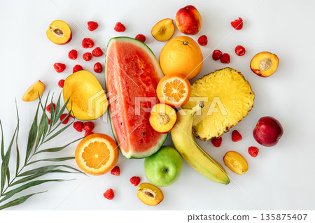 Tropical fruits on a white background top view. Tropical fruits on a white background top view. 135875407