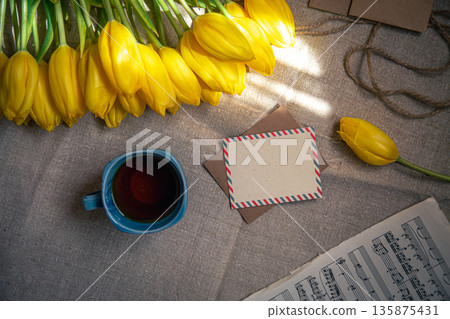 Vintage composition with a cup of tea, tulips and notes, flat lay. Vintage composition with a cup of tea, tulips and notes, flat lay. 135875431