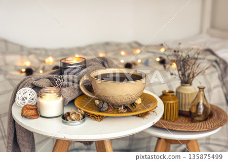 Cozy autumn composition with a cup of tea and decorative details. 135875499
