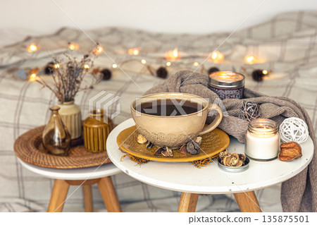 Cozy autumn composition with a cup of tea and decorative details. Cozy autumn composition with a cup of tea and decorative details. 135875501