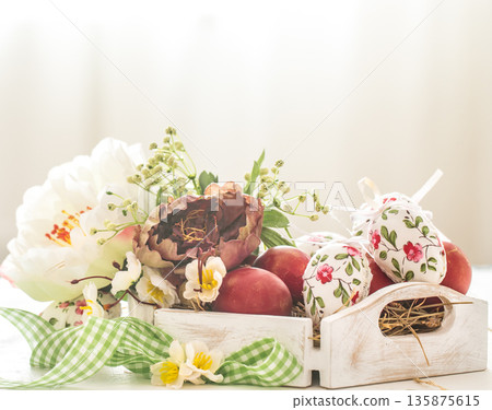 Easter background with a basket and red eggs with flowers Easter background with a basket and red eggs with flowers 135875615