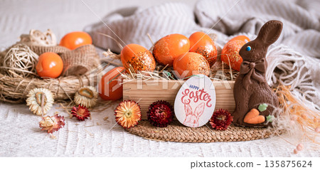Easter still life with orange eggs, holiday decor . 135875624