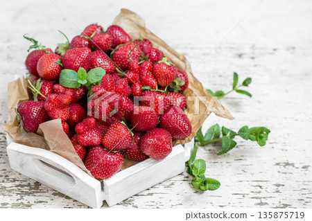 Fresh strawberries on a wooden tray Fresh strawberries on a wooden tray 135875719