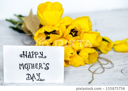 postcard Mother's Day and yellow tulips on wooden background postcard Mother's Day and yellow tulips on wooden background 135875756