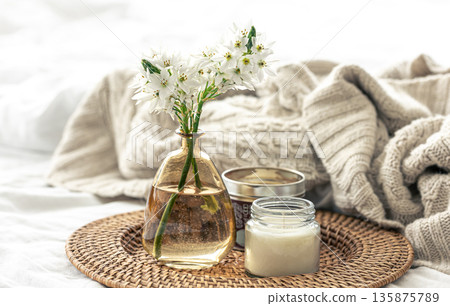 Home composition with flowers in vases and a knitted element. Home composition with flowers in vases and a knitted element. 135875789