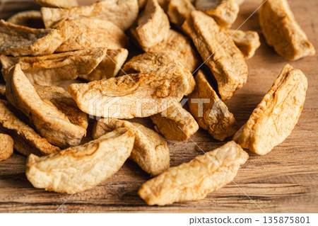 Homemade dried organic apple sliced on wood background. Homemade dried organic apple sliced on wood background. 135875801