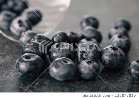 Macro photography, blueberries scattered on a dark surface. Macro photography, blueberries scattered on a dark surface. 135875830