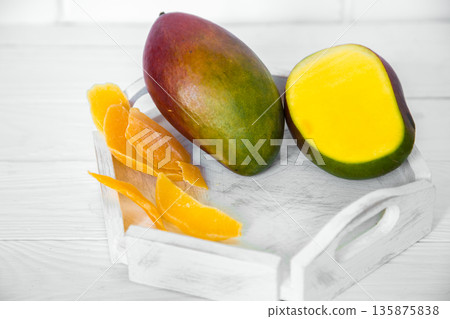 Mango on white wooden background Mango on white wooden background 135875838