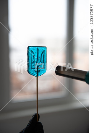 Patriotic lollipop in the shape of the coat of arms of Ukraine. 135875977