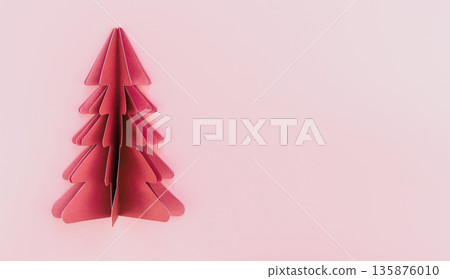 A pink paper origami christmas tree on pink background isolated, copy space. A pink paper origami christmas tree on pink background isolated, copy space. 135876010
