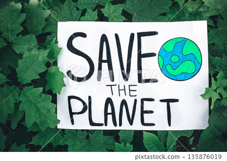 Poster with the inscription save the planet in the forest among the plants. Poster with the inscription save the planet in the forest among the plants. 135876019