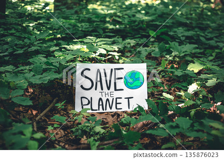 Poster with the inscription save the planet in the forest among the plants. 135876023