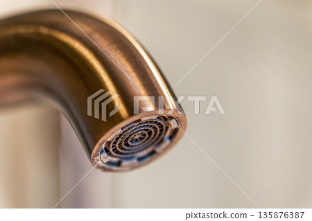 Aerator closeup. Copper glow. Modern faucet. Aerator closeup. Copper glow. Modern faucet. 135876387