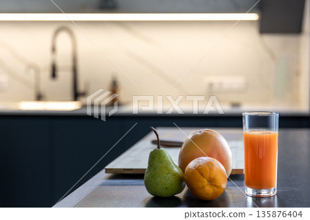 Fresh set in home kitchen near board and knife. Orange juice. Fresh set in home kitchen near board and knife. Orange juice. 135876404