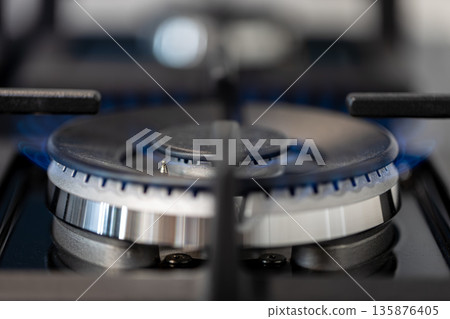 Gas stove in action. Metallic burner. Macro focus. Gas stove in action. Metallic burner. Macro focus. 135876405