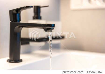 Black faucet water. Minimal sink. Modern bathroom Black faucet water. Minimal sink. Modern bathroom 135876462