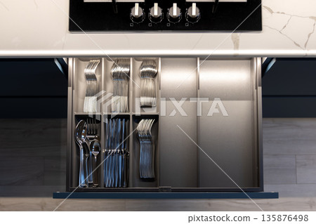 Drawer with cutlery. Modern kitchen. Integrated organization. Drawer with cutlery. Modern kitchen. Integrated organization. 135876498
