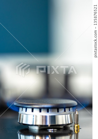 Gas burner macro. Blue flame. Modern cooktop 135876521
