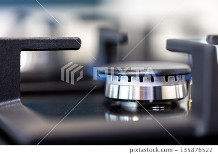 Gas burner macro. Flame detail. Modern kitchen surface. Gas burner macro. Flame detail. Modern kitchen surface. 135876522