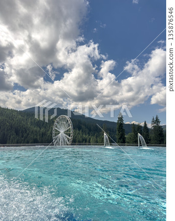 Infinity pool. Mountain view. Ferris wheel Infinity pool. Mountain view. Ferris wheel 135876546