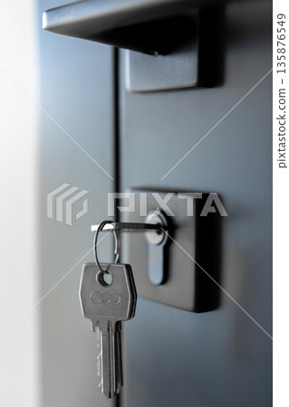 Key in lock. Black hardware. Minimal door. 135876549