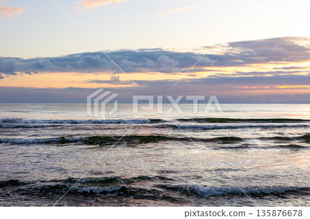 Sea waves at sunset. Evening horizon and calm. Sea waves at sunset. Evening horizon and calm. 135876678