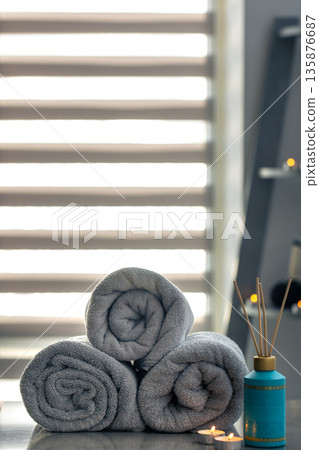 Spa setup with towels and diffuser Spa setup with towels and diffuser 135876687