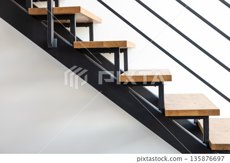 Step detail closeup. Wood on black steel. Industrial interior. 135876697