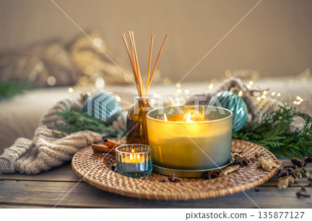 Cozy Christmas composition with candles and aroma sticks. Christmas concept. 135877127