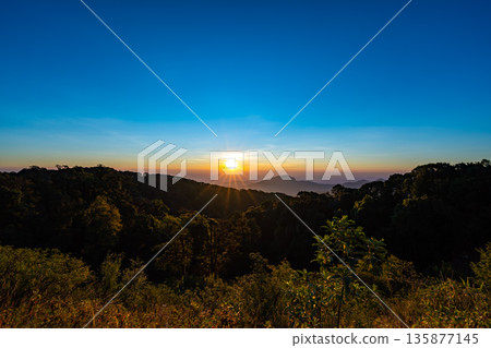 The beautiful sunrise at Doi intanon national park, Chiang Mai in the morning.Sun is rising from the hill to shy with beautiful yellow orange light. 135877145