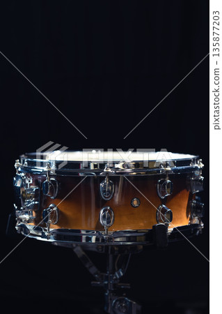 Drum close-up. Drum on a black background. Copy space. Drum close-up. Drum on a black background. Copy space. 135877203