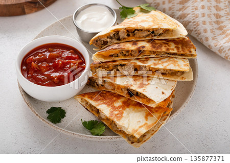 Ground turkey and cheddar quesadillas with salsa 135877371