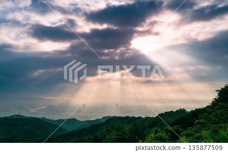 Dramatic Taipei City Sunrise with God Rays from Dadao Mountain Shulin. Dramatic Taipei City Sunrise with God Rays from Dadao Mountain Shulin. 135877509