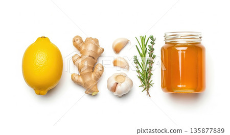 Fresh lemon, ginger root, garlic cloves, rosemary sprigs, and honey jar arranged on a white background, showcasing natural ingredients for healthy cooking and wellness Fresh lemon, ginger root, garlic cloves, rosemary sprigs, and honey jar arranged on a white background, showcasing natural ingredients for healthy cooking and wellness 135877889