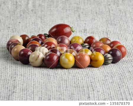 Prayer beads made of the mukaite jasper on burlap background. These 33-bead prayer beads are traditionally used in Christian and Islamic prayer practices Prayer beads made of the mukaite jasper on burlap background. These 33-bead prayer beads are traditionally used in Christian and Islamic prayer practices 135878370
