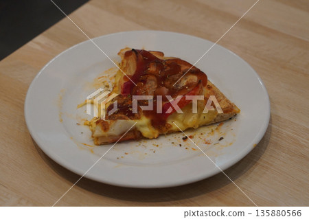 top view hot crab stick and pineapple pizza and topped with ketchup in a white ceramic plate on a wooden table background, food, copy space 135880566