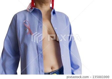 Woman wearing pink ribbon for breast cancer awareness 135881000