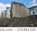 Remains of almost destroyed one-story residential private house in form of standing brick walls, piles of construction debris or building. Renovation program. High cost of land for sale in cities 135881105