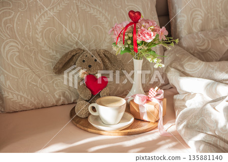Romantic Breakfast in Bed with Plush Bunny and Gift. Cozy Valentines Day Lifestyle Romantic Breakfast in Bed with Plush Bunny and Gift. Cozy Valentines Day Lifestyle 135881140