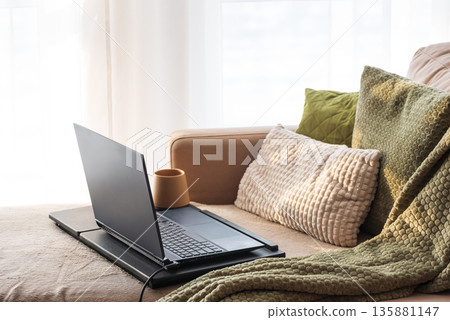 Laptop and Coffee Mug on Lap Desk. Cozy Morning Home Workspace with Green Accents 135881147