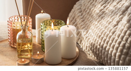 Candles and Reed Diffuser on Wooden Tray. Cozy Home Decor lifestyle with Cushions 135881157